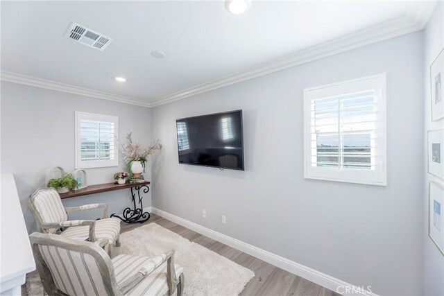 sitting room with ornamental molding, light hardwood / wood-style flooring, and plenty of natural light