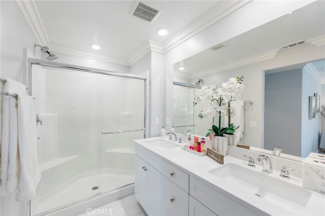 bathroom featuring ornamental molding, a shower with shower door, and vanity