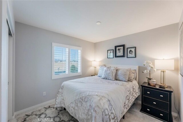 carpeted bedroom with a closet