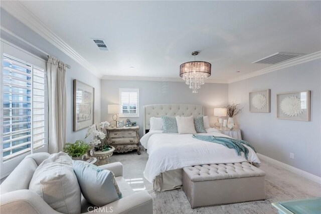 carpeted bedroom featuring crown molding and an inviting chandelier