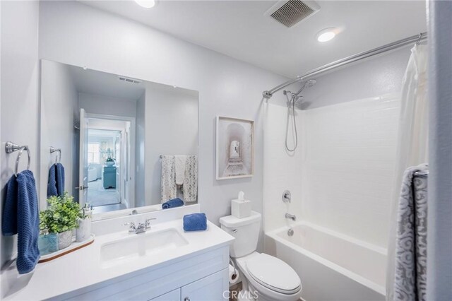 full bathroom with toilet, vanity, and shower / tub combo with curtain