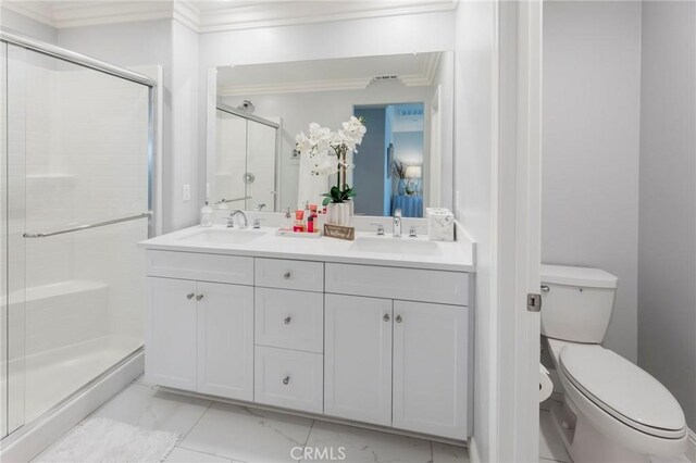 bathroom featuring toilet, a shower with shower door, and vanity