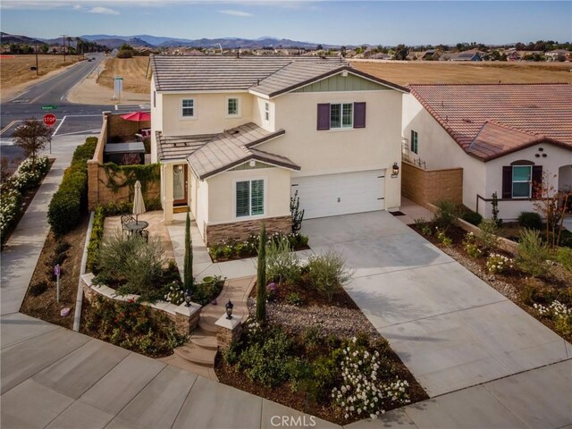 view of front of property featuring a garage and a mountain view