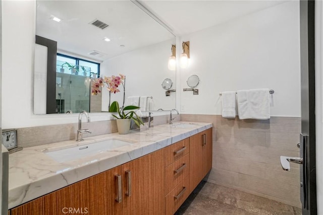 bathroom with vanity and tile walls