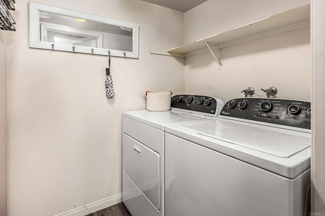 laundry room with separate washer and dryer and dark hardwood / wood-style floors