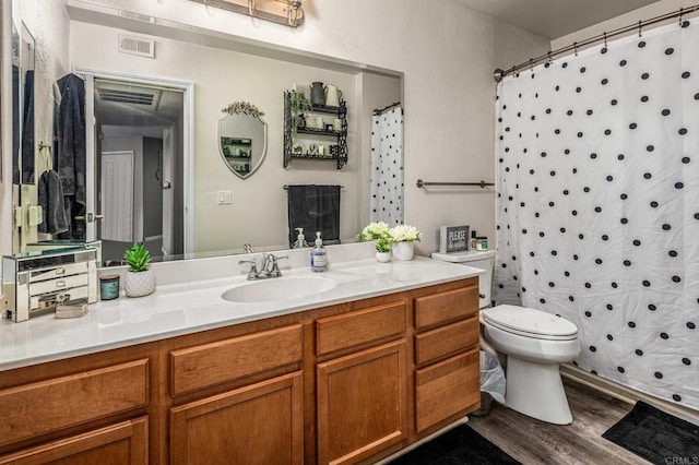 bathroom featuring a shower with shower curtain, vanity, hardwood / wood-style flooring, and toilet