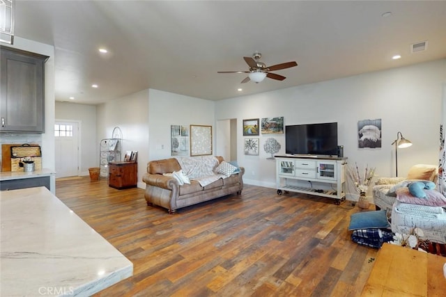 living room with dark hardwood / wood-style floors and ceiling fan