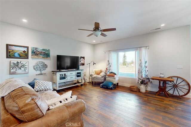 living room with dark wood-type flooring and ceiling fan