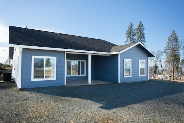 rear view of property with central AC and a patio