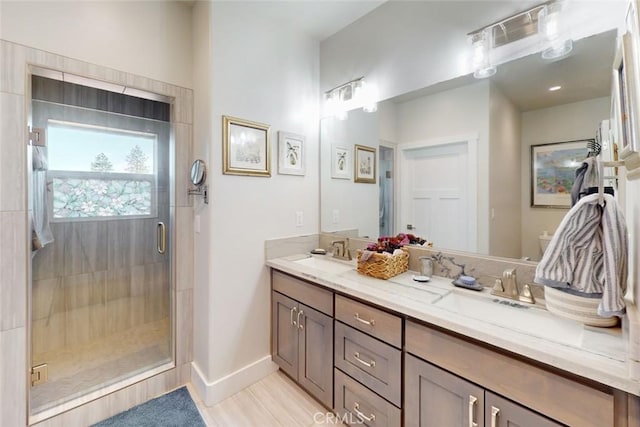 bathroom with vanity and a shower with door