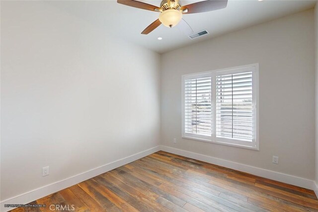 empty room with dark hardwood / wood-style floors and ceiling fan