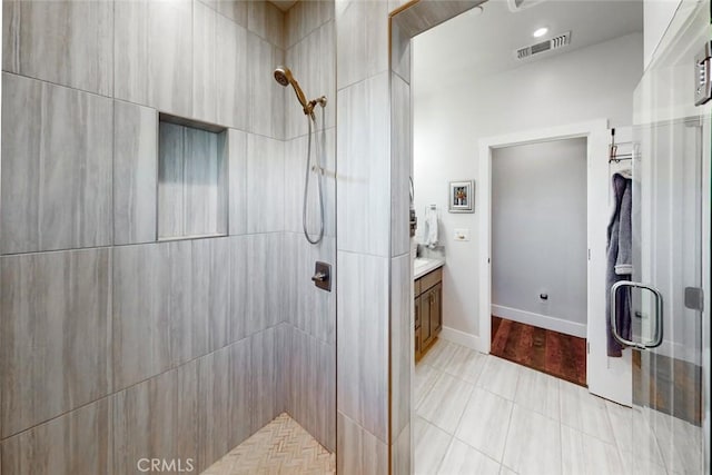 bathroom with vanity and a shower with door