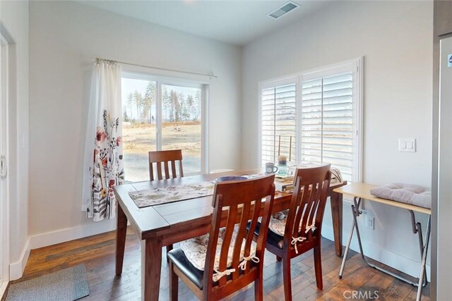 dining area with dark wood-type flooring