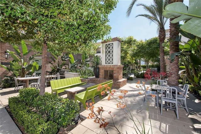 view of patio / terrace with an outdoor brick fireplace