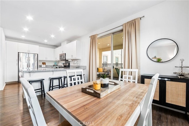 dining area with dark hardwood / wood-style floors