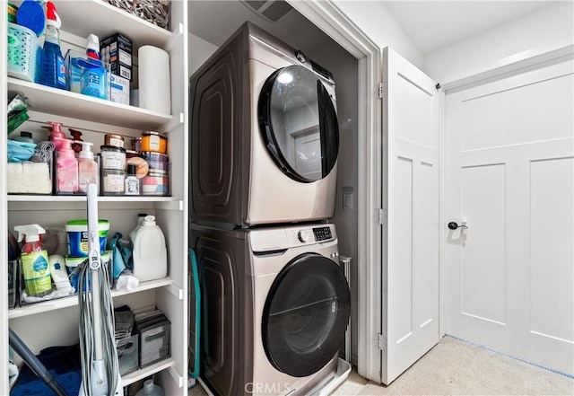 washroom featuring stacked washer and dryer