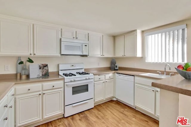 kitchen featuring white appliances and white cabinets