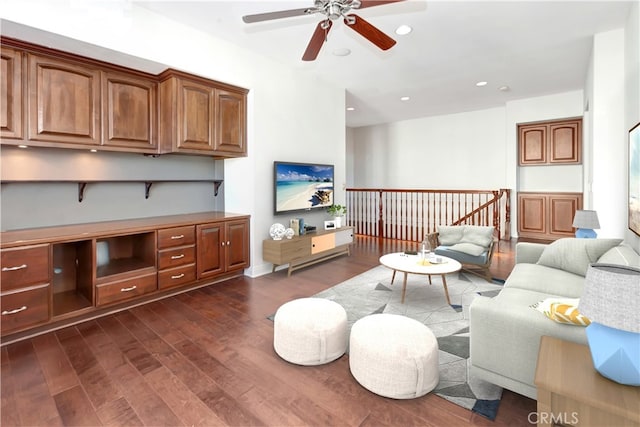 living room featuring ceiling fan and dark wood-type flooring