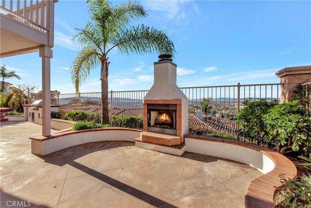 view of patio with a tile fireplace