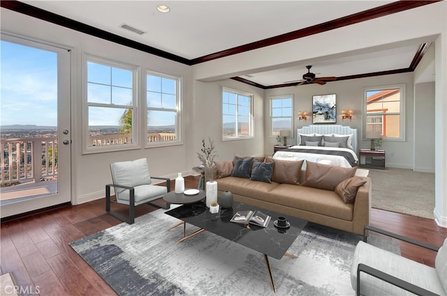 bedroom featuring access to outside, dark wood-type flooring, ceiling fan, and multiple windows