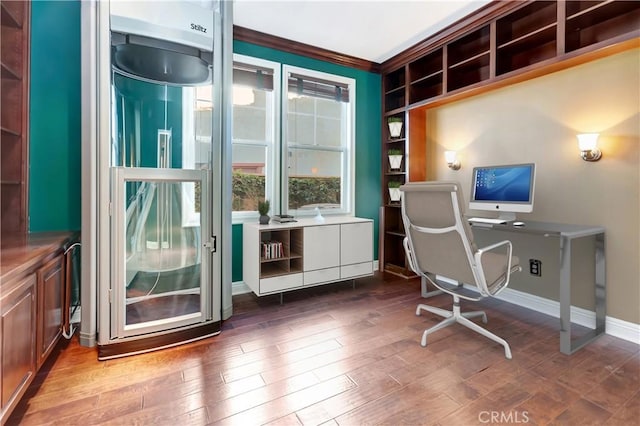 office with dark hardwood / wood-style flooring and crown molding