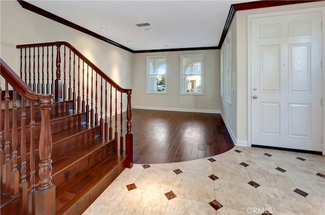 foyer entrance featuring crown molding and wood-type flooring