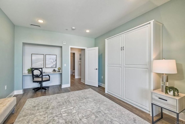 office with dark hardwood / wood-style flooring