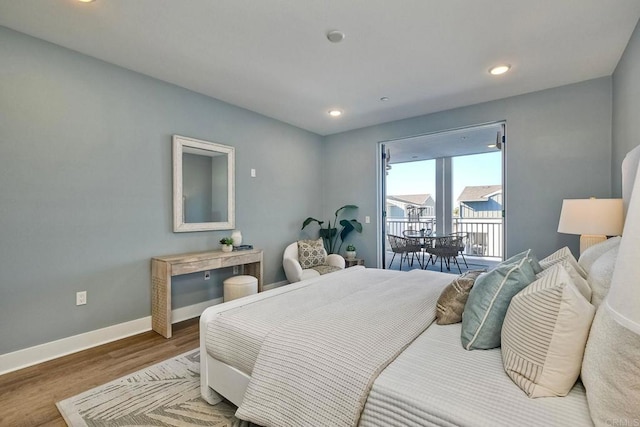 bedroom featuring access to outside and hardwood / wood-style flooring