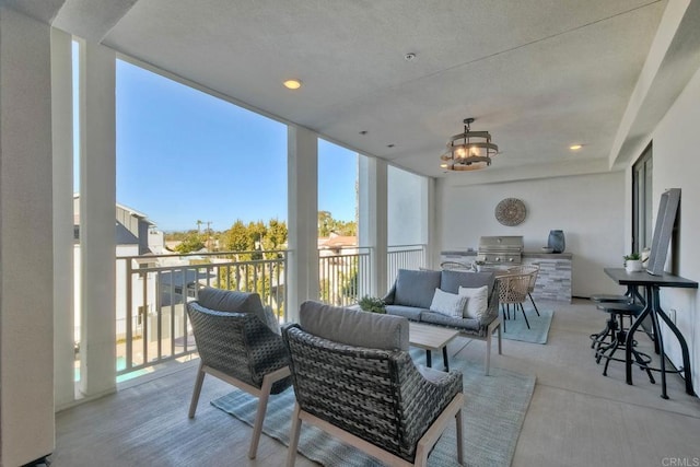 view of patio with an outdoor kitchen, area for grilling, a balcony, and outdoor lounge area