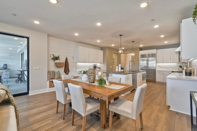 dining area with sink and light hardwood / wood-style flooring