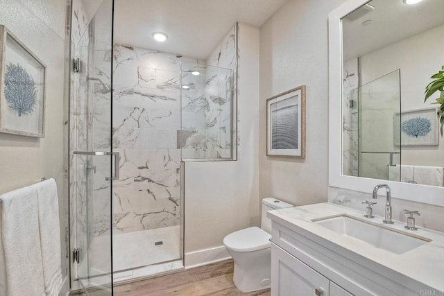 bathroom with toilet, an enclosed shower, vanity, and hardwood / wood-style floors