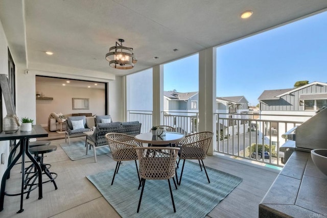 sunroom / solarium with a chandelier