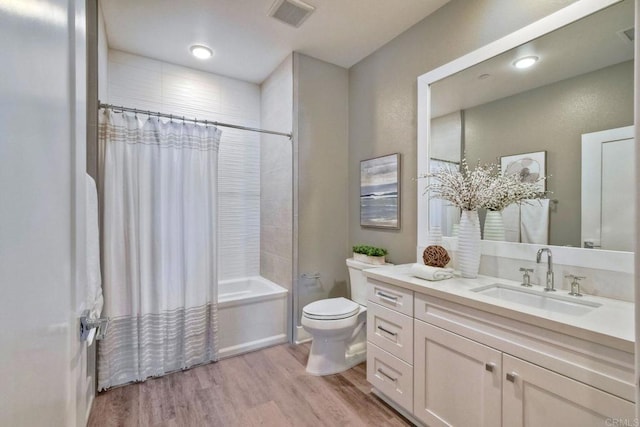 full bathroom featuring toilet, shower / tub combo with curtain, vanity, and hardwood / wood-style flooring