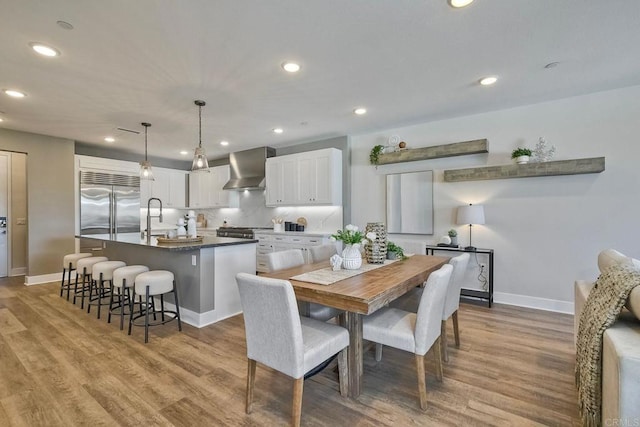 dining area featuring sink and light hardwood / wood-style flooring