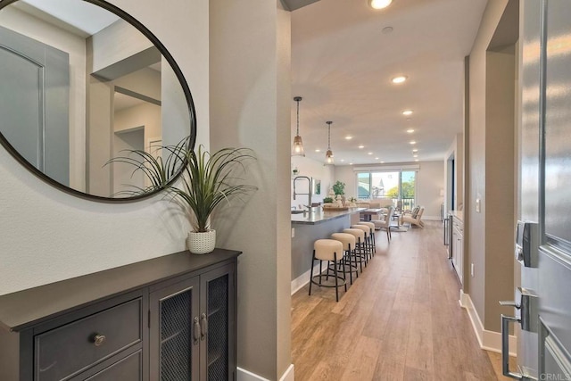 corridor with light hardwood / wood-style flooring