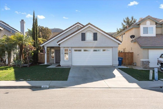 front facade with a front yard and a garage