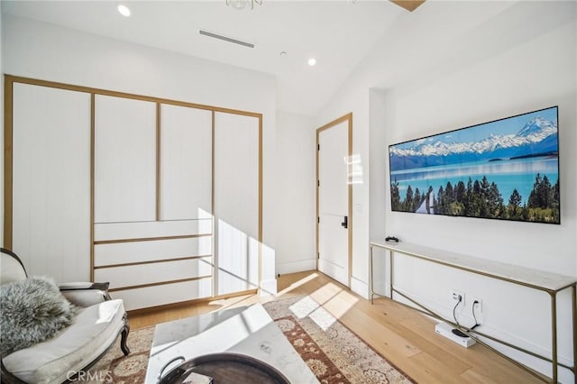 interior space with hardwood / wood-style floors and lofted ceiling