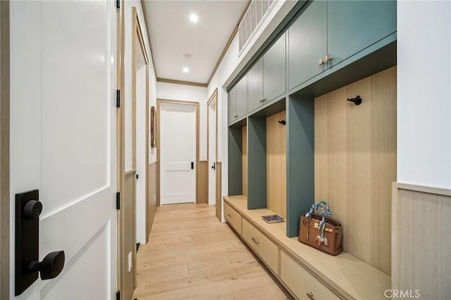 mudroom with light wood-type flooring and ornamental molding