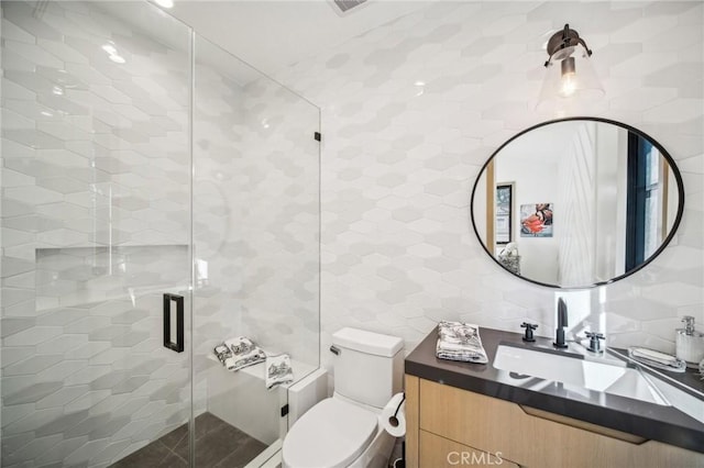 bathroom with toilet, decorative backsplash, vanity, and tile walls