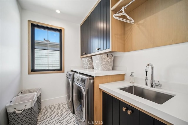 laundry room with cabinets, sink, washing machine and dryer, and light tile patterned flooring