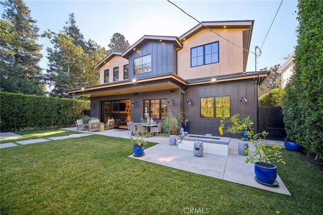 rear view of property with a lawn and a patio