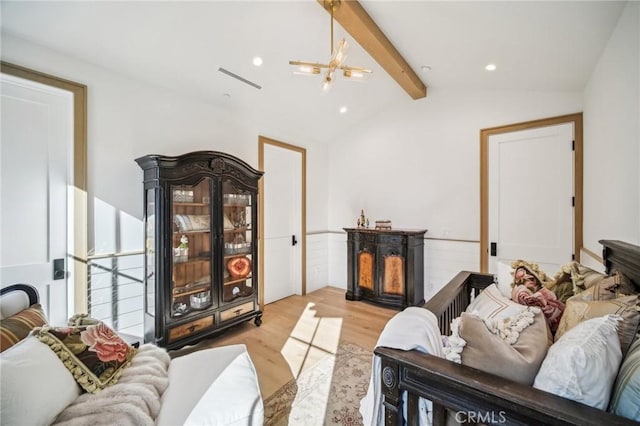 living room featuring light wood-type flooring, vaulted ceiling with beams, and an inviting chandelier