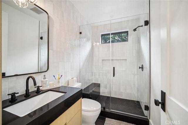 bathroom featuring an enclosed shower, vanity, decorative backsplash, tile walls, and toilet