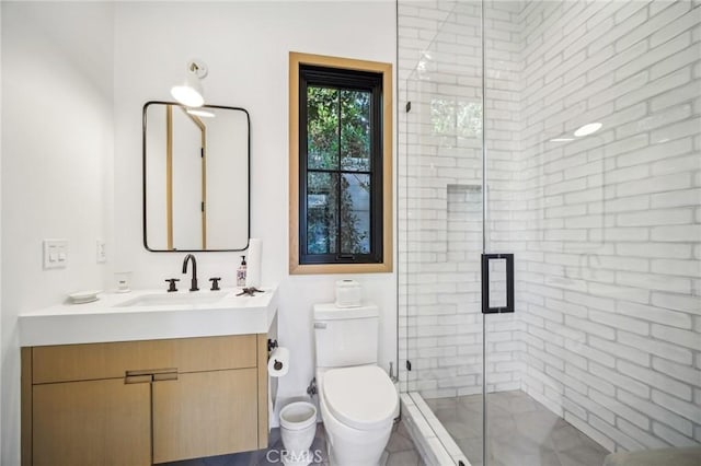 bathroom with a shower with door, toilet, and vanity