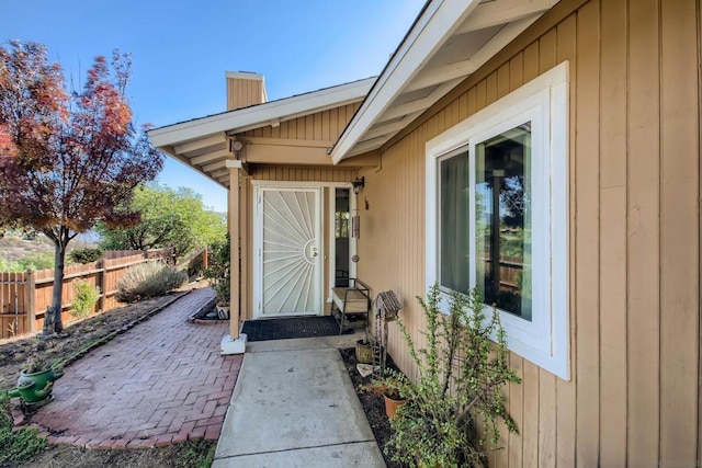 view of exterior entry featuring a patio