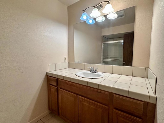 bathroom featuring tile patterned flooring and vanity