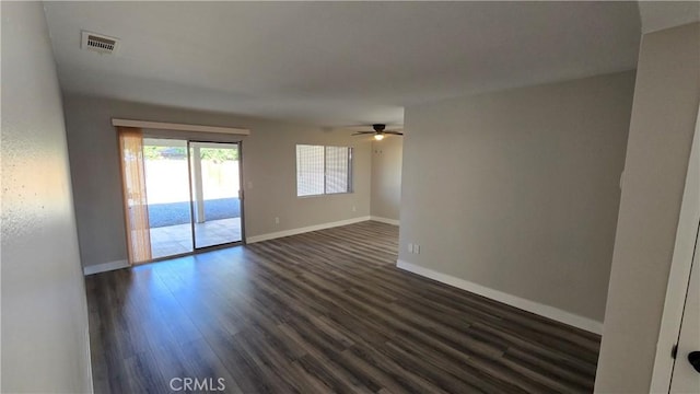 unfurnished room with ceiling fan and dark hardwood / wood-style floors