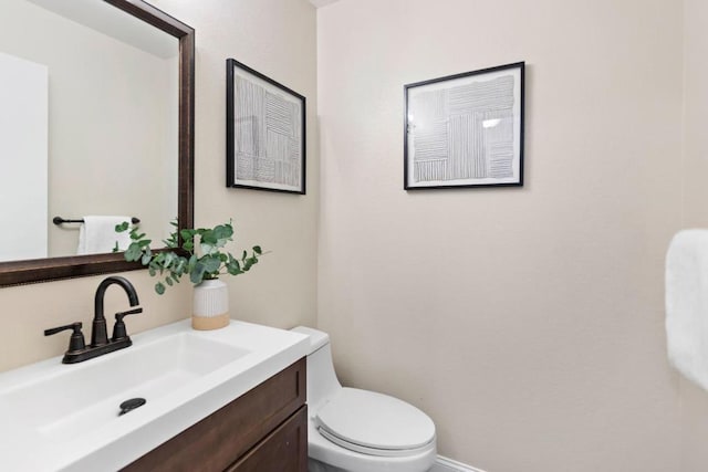 bathroom featuring toilet and vanity