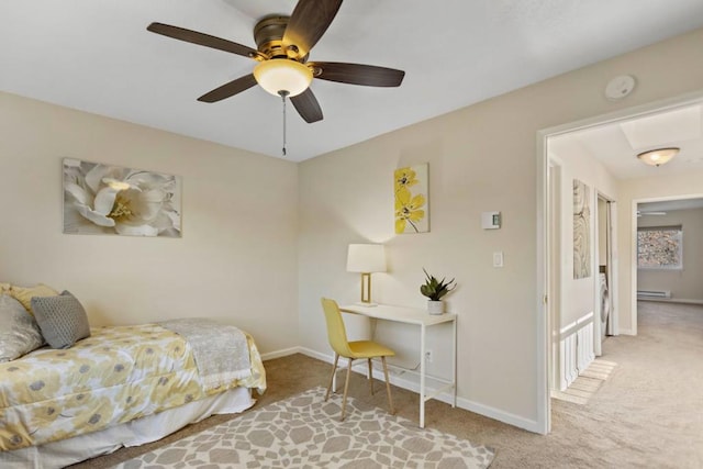 bedroom featuring ceiling fan, baseboard heating, and light colored carpet