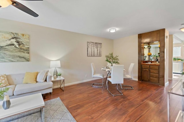 dining space with ceiling fan and dark hardwood / wood-style flooring